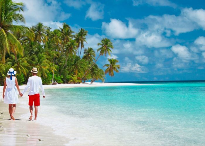 happy loving couple walking on beach, vacation concept